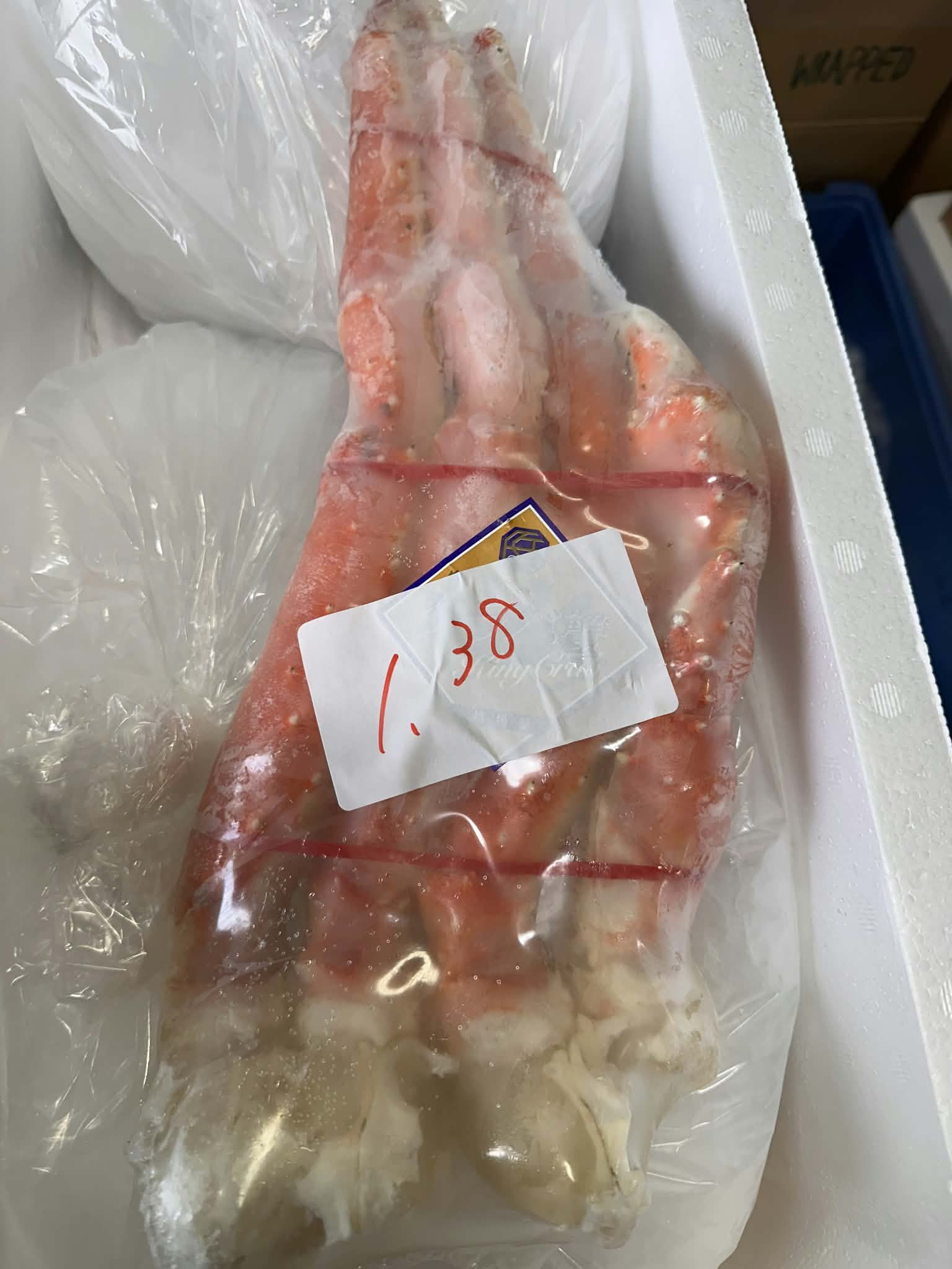 Frozen Alaskan king crab cluster packed in an insulated cold box